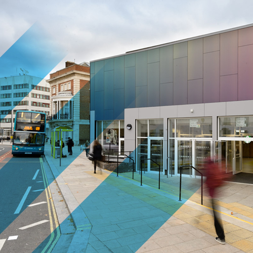 A student walking down the road past the Guild building